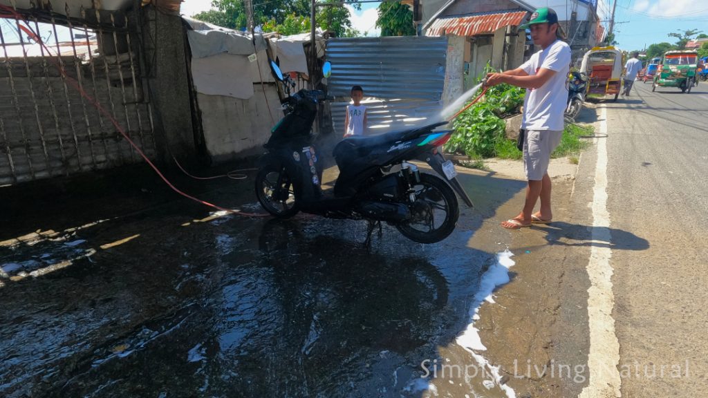 Man washing a motor bike